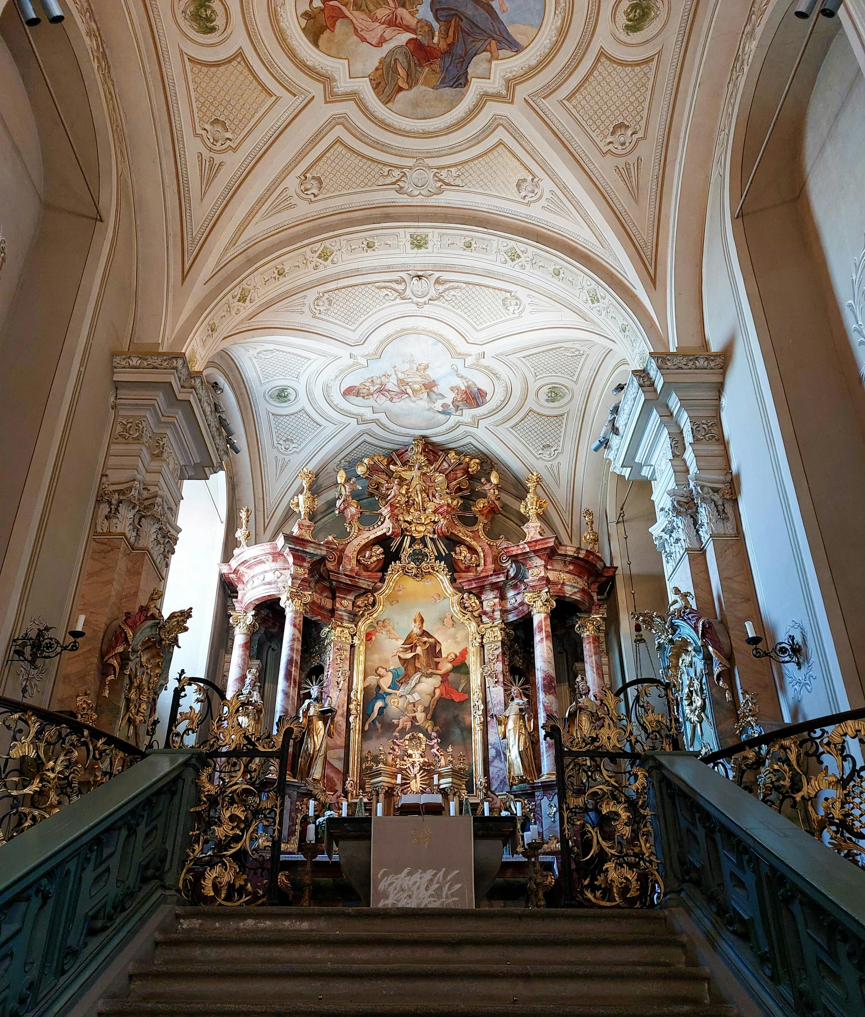 a cathedral with ornate ceilings and railings and paintings on the ceiling