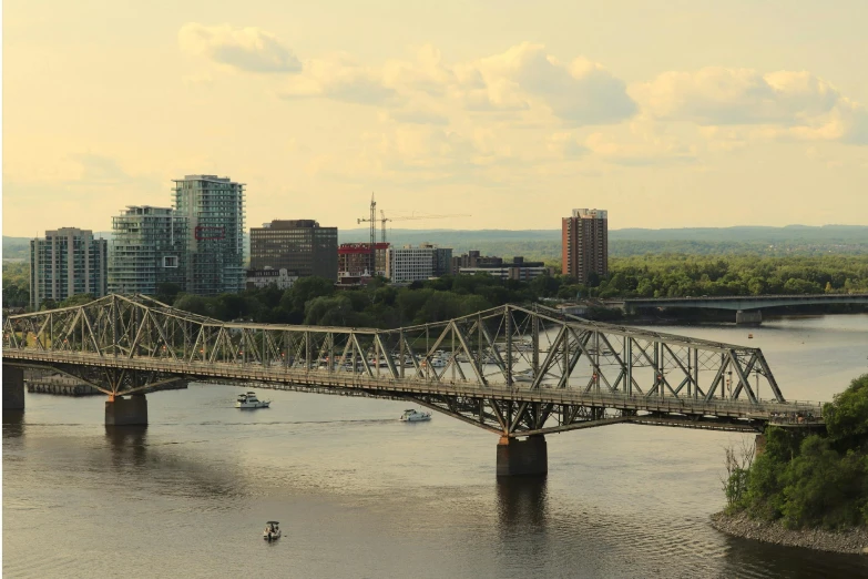 a large long bridge over a river in the city