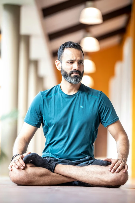 man sitting in a lotus position with his hands crossed