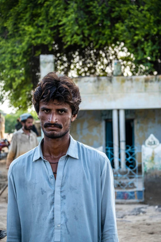 a man stands in front of two people