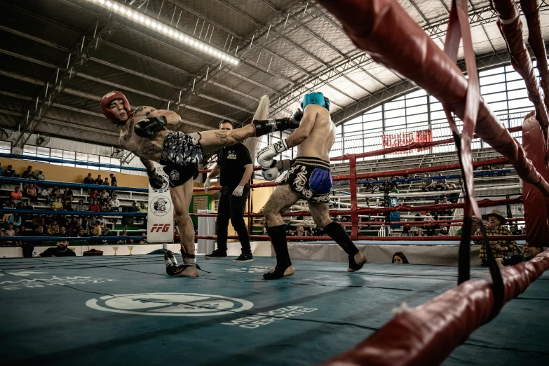 boxers are in the middle of competition at an indoor venue