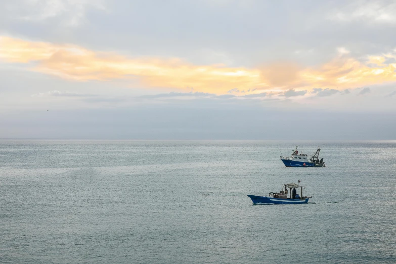 two fishing boats in a large body of water