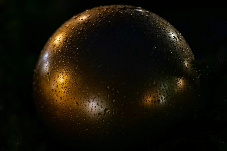 a black ball with rain drops all over it