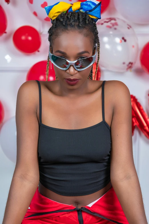 a person sitting down with some balloons in the background