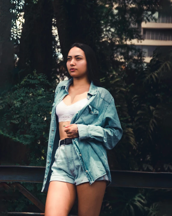 a beautiful woman standing in shorts, shirt and jacket