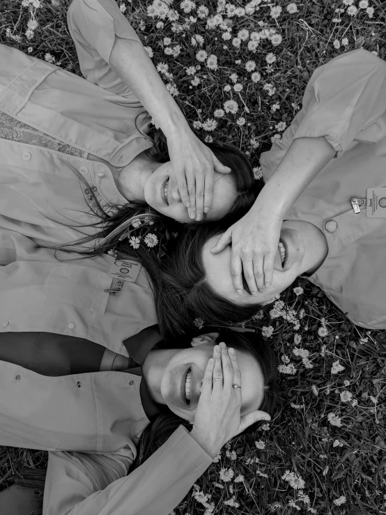 a couple lying on the ground together and looking up