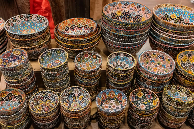 many bowls are stacked together on display