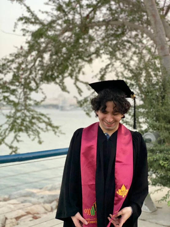 a man in a graduation gown and cap