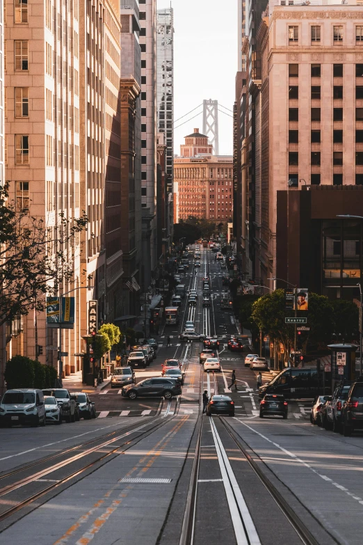 an old street with traffic on it with buildings and people