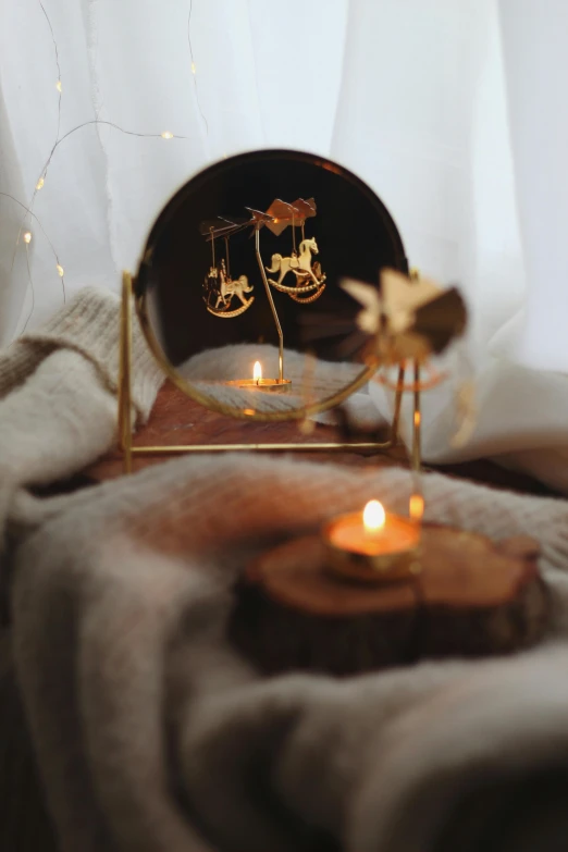 a gold ring with candles on a table