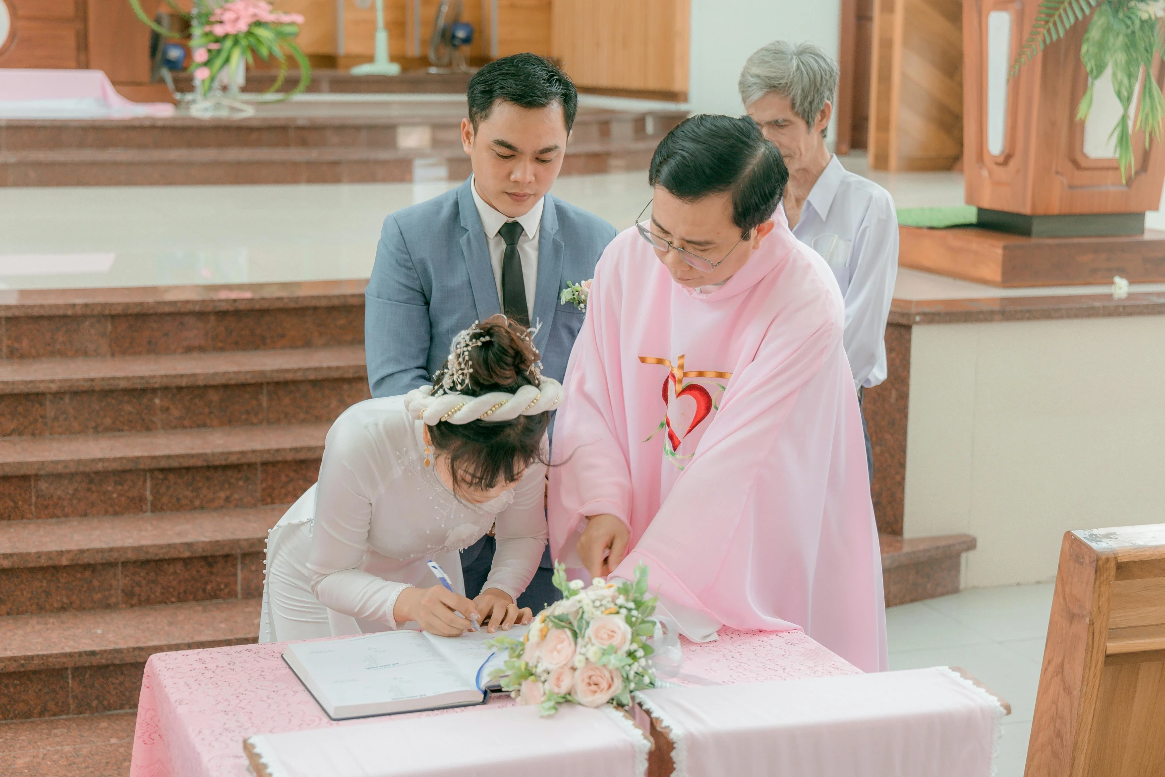 the man and woman are signing their marriage register