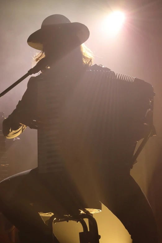 the person is playing a guitar on stage