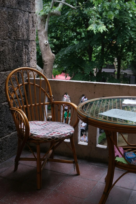 two chairs and table with a tree and a window