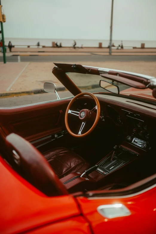 an older model sports car with the top down