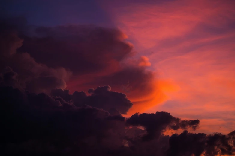 clouds in the sky during sunset and the sun is going down