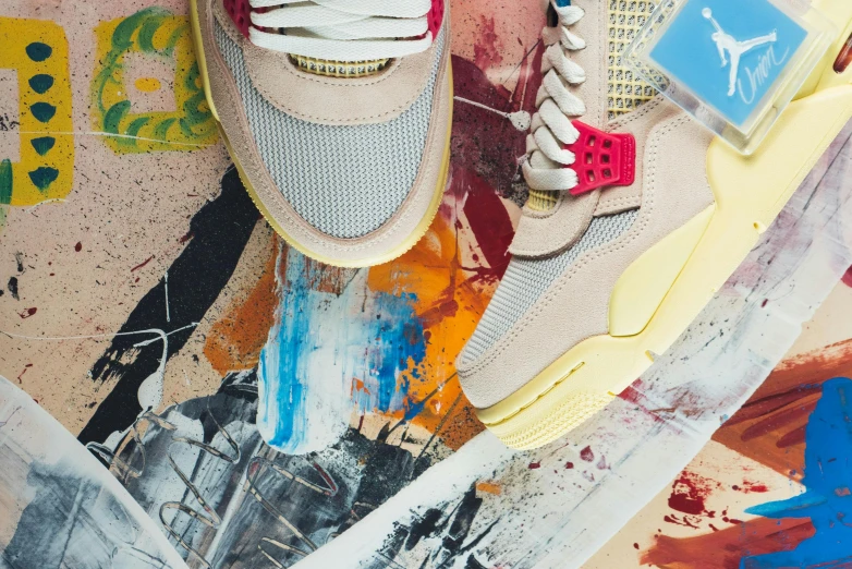 a person's sneakers are laying on an abstract painting