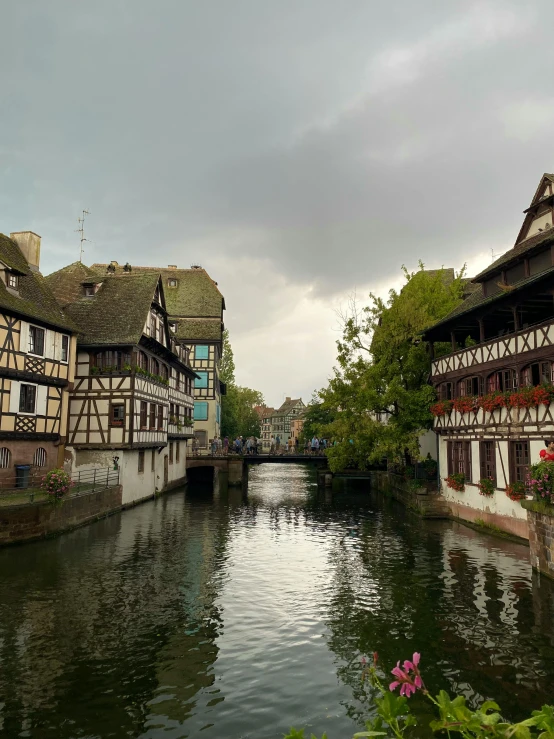 some buildings sit along a river in a european area