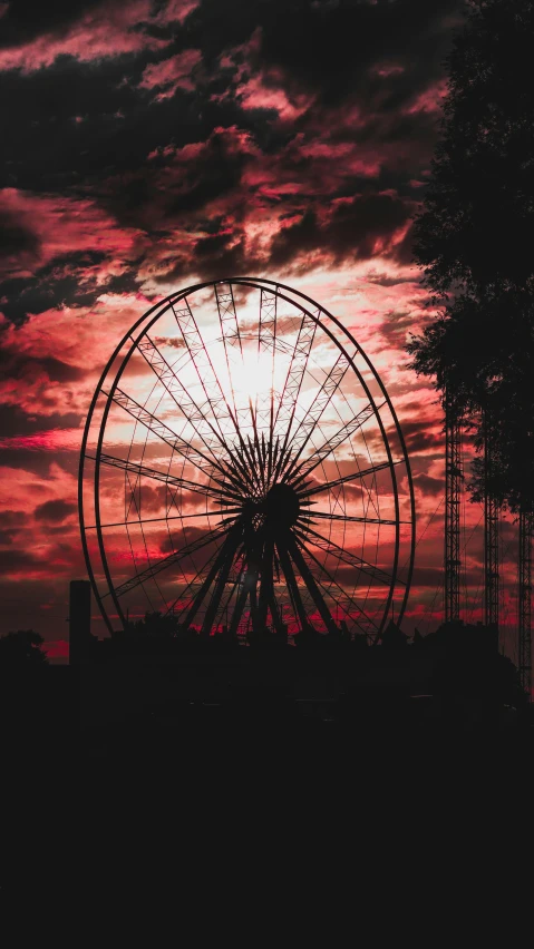 an amut wheel with the sun setting in the background