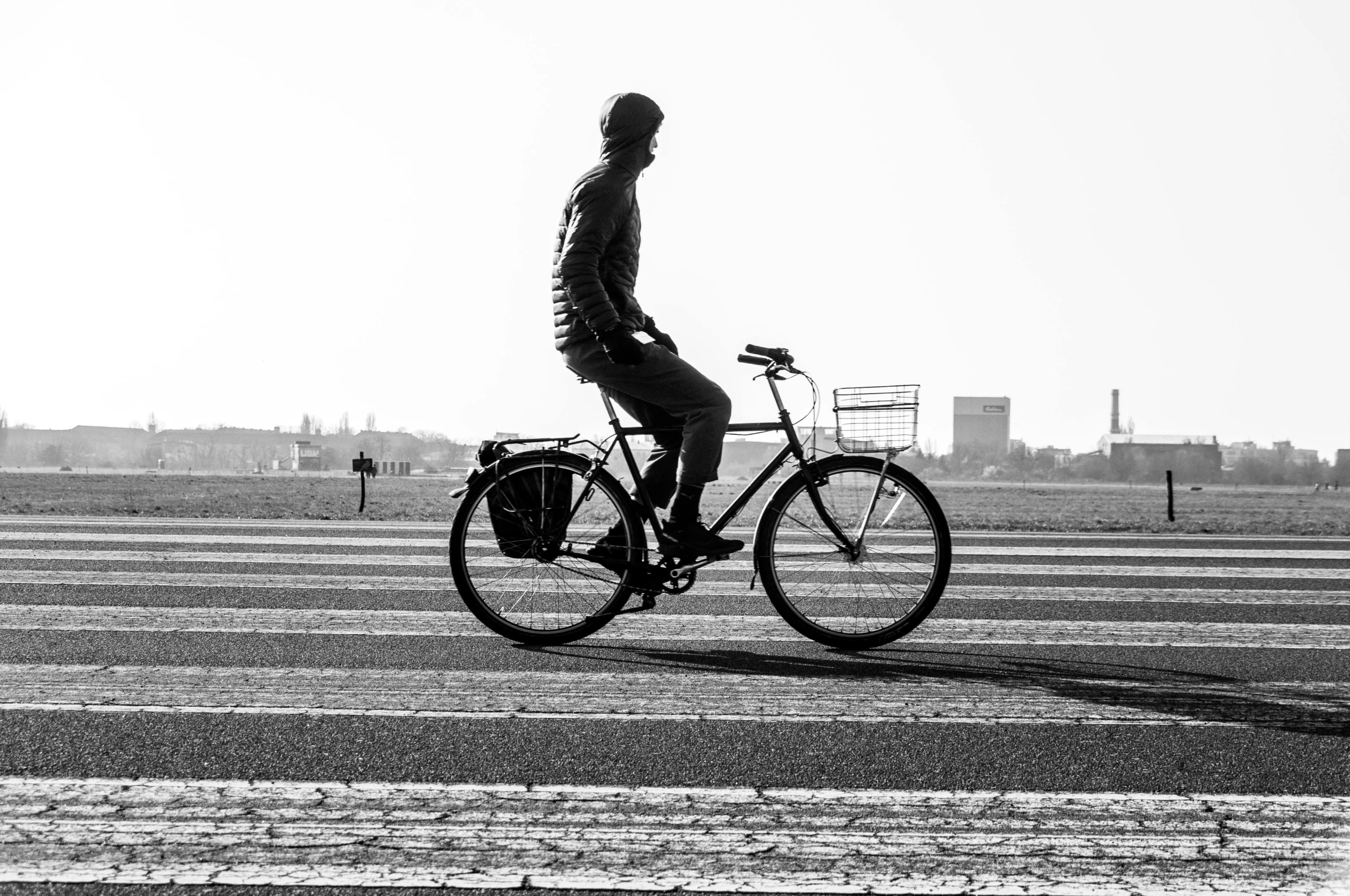 a black and white po of a man riding his bicycle