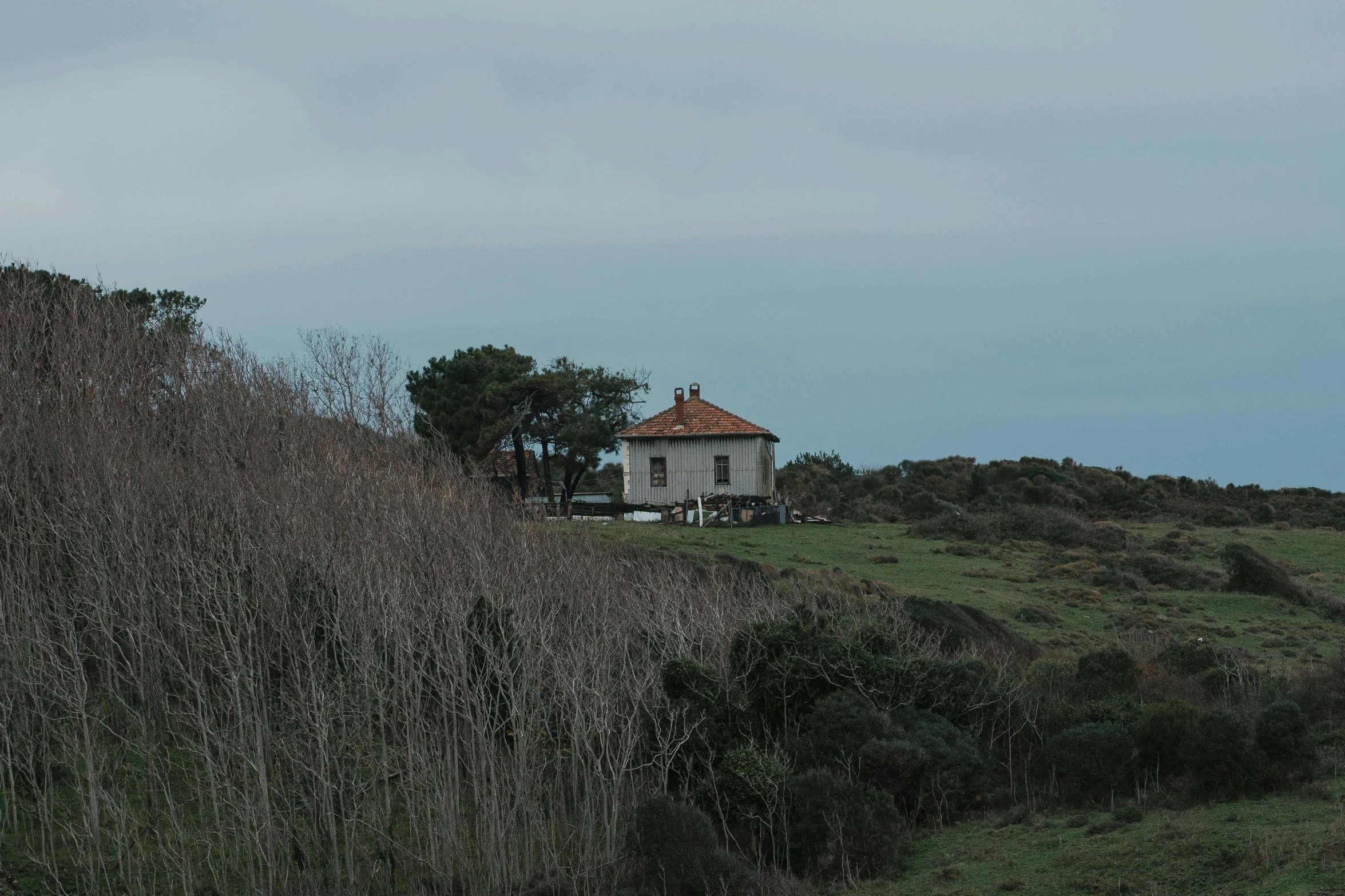 a tall white building sitting on the side of a hill