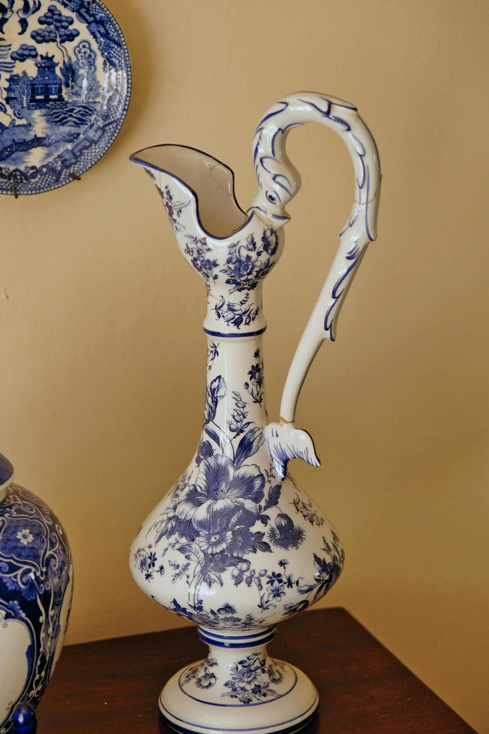 an antique blue and white vase with an interesting handle