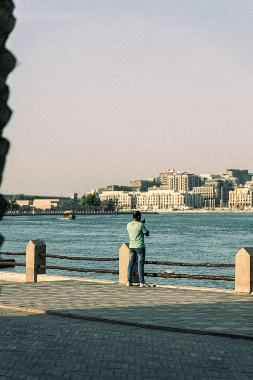 a man that is standing on the side of a river