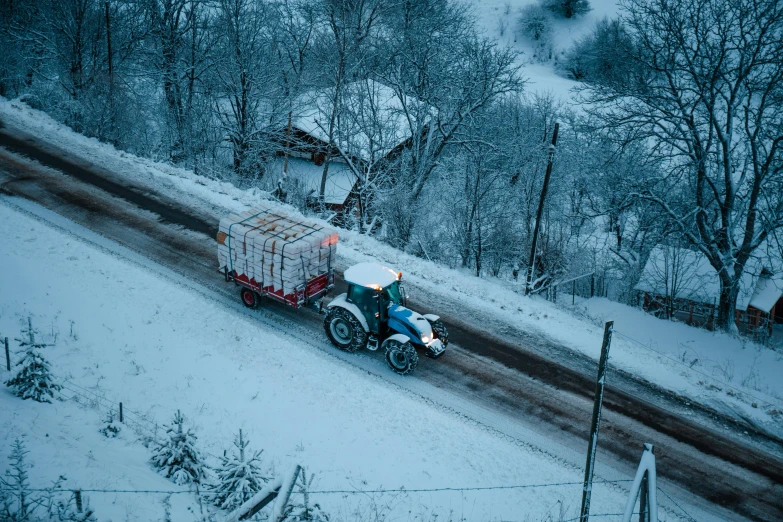 a truck driving on a snow covered road