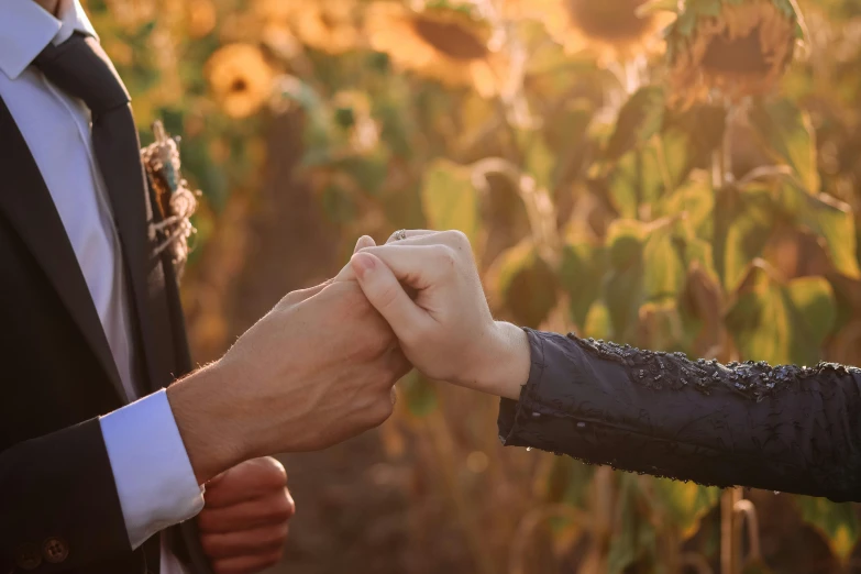 a couple standing close to each other holding hands