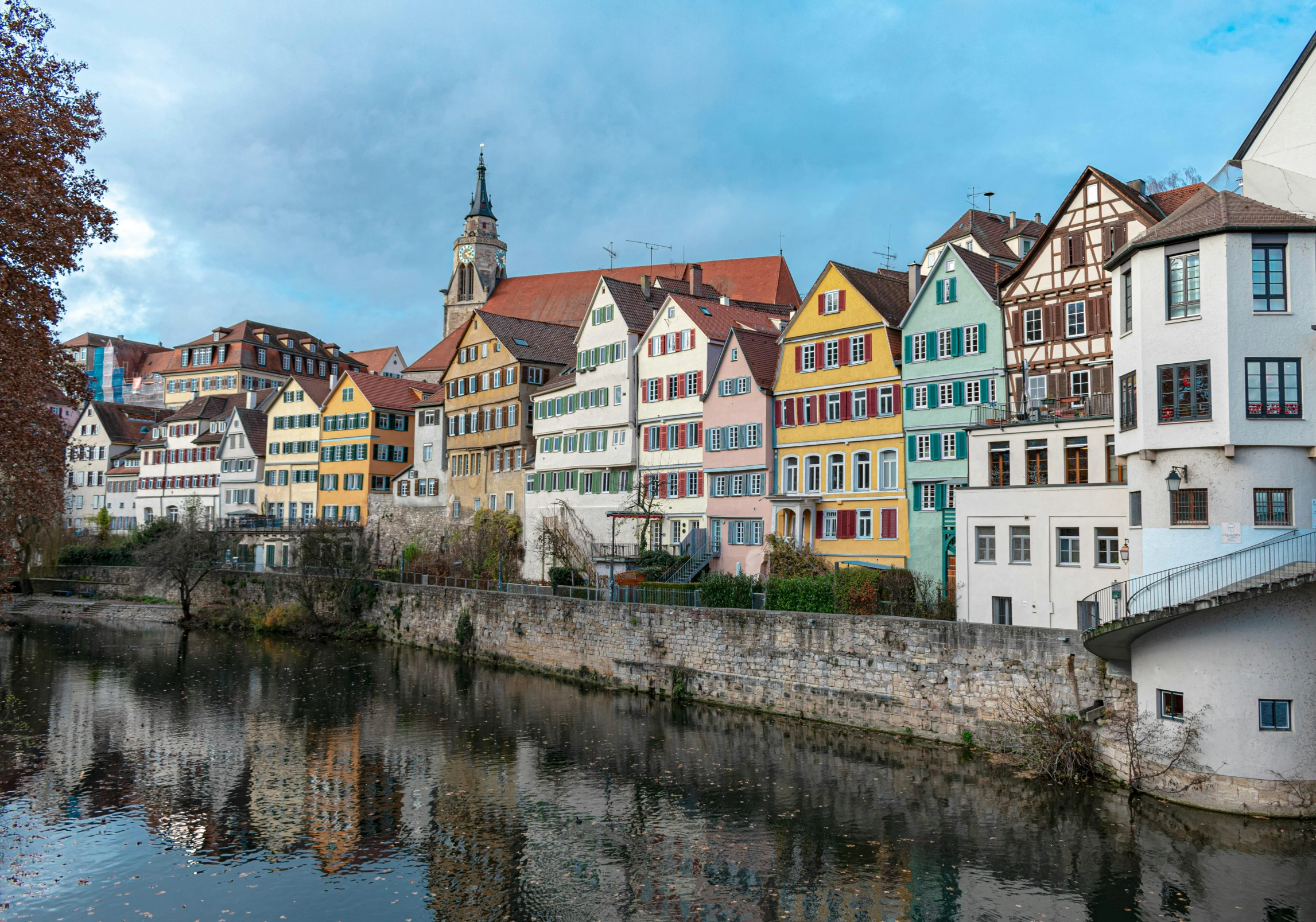 the buildings of different ages are reflected in the water