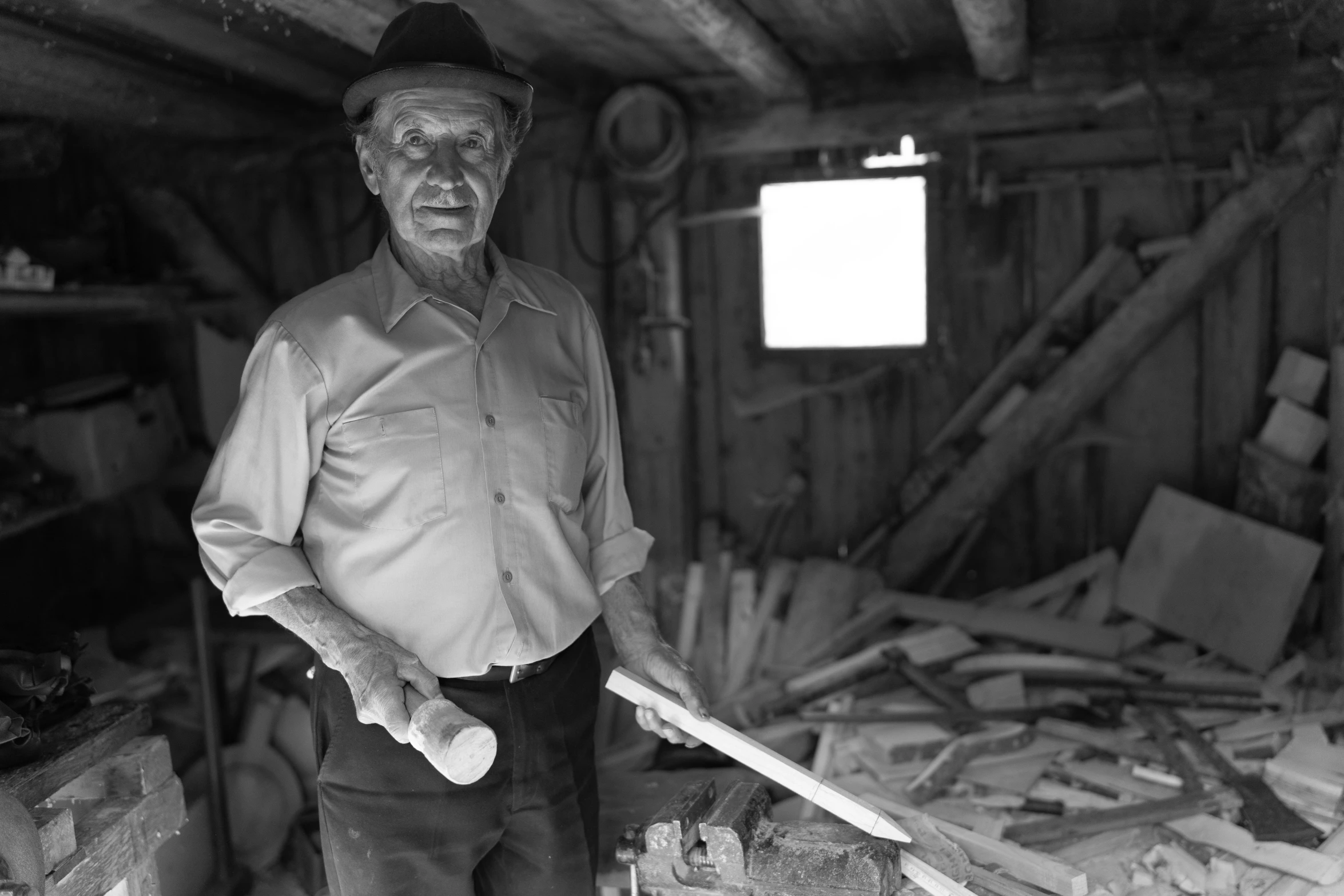 the man in a gray shirt is standing with a baseball bat