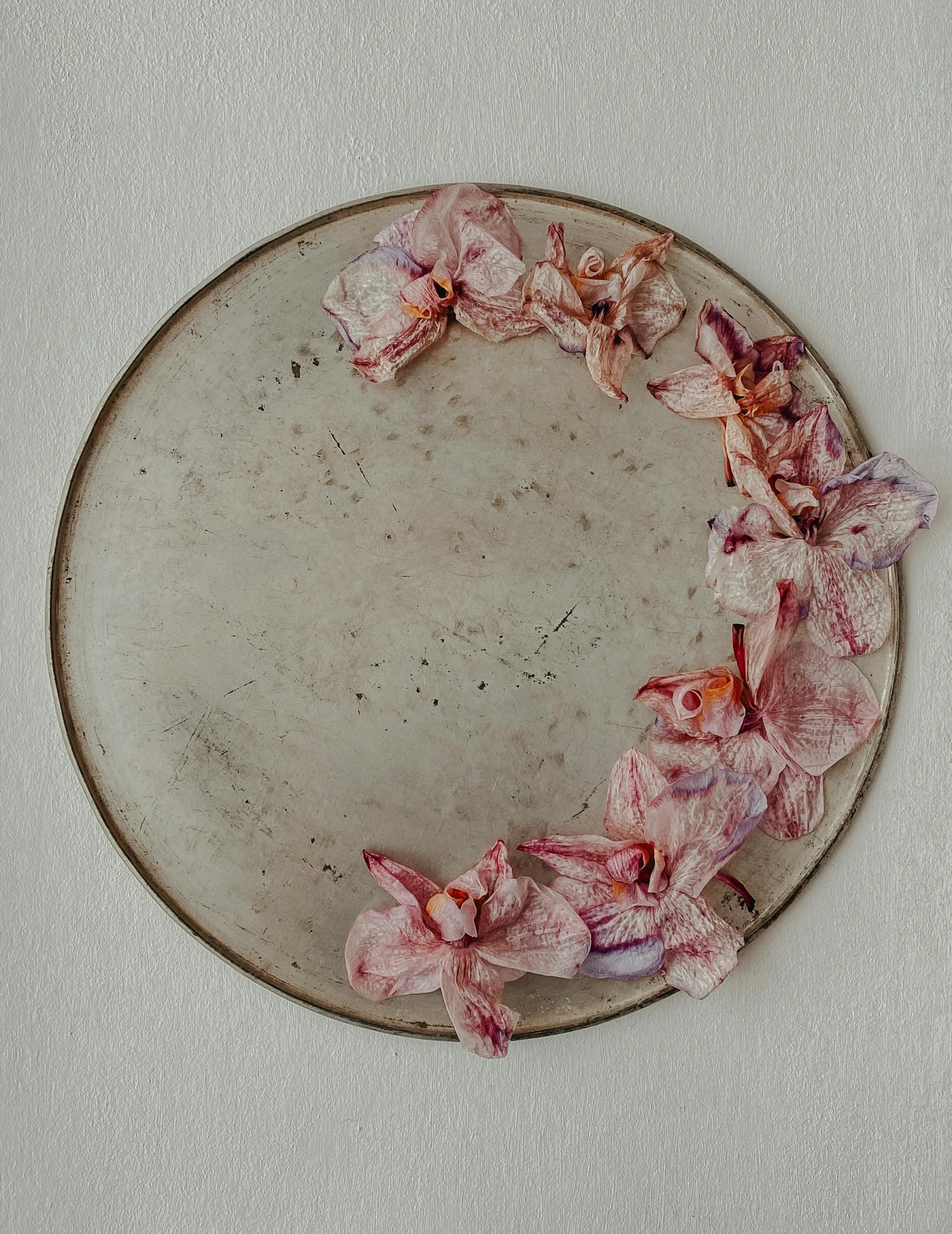 a plate with pink flowers placed in it