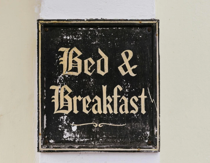 an old sign advertising bed & breakfast displayed on the wall