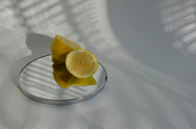 a lemon on a silver rim with sunlight coming through