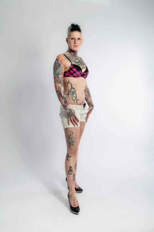 a tattooed girl in underwear with lots of tattoos