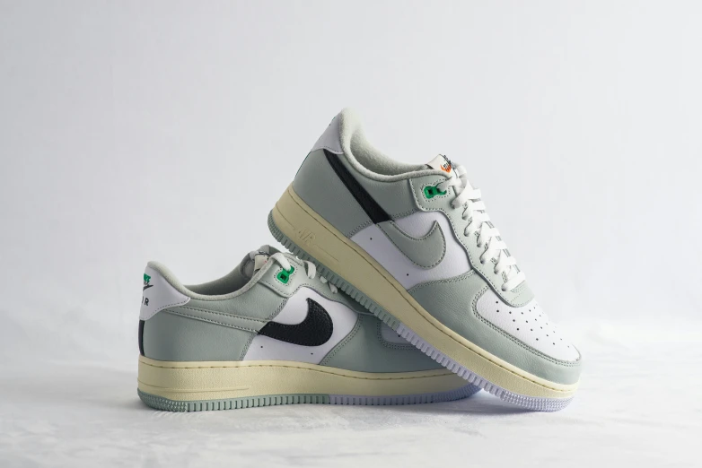 the nike air force is a green and white shoe