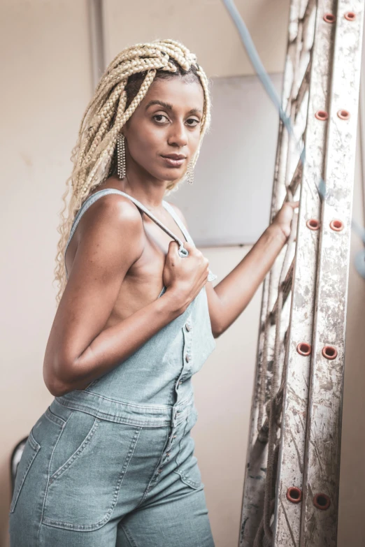 woman posing in jeans with her hands on a rope