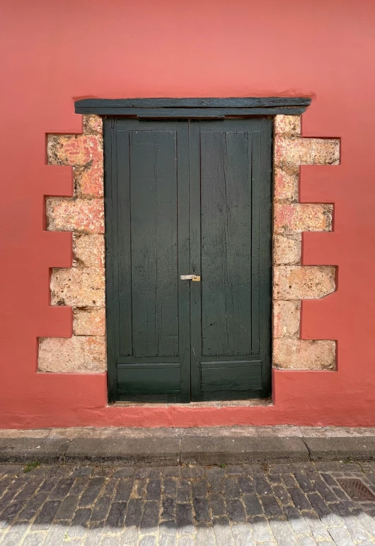 a black and red building with a wood door