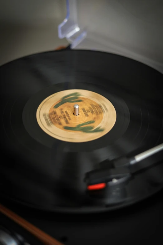 a record player's turntable with a record being pressed in it