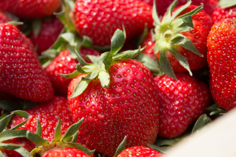 several red strawberries grouped together in the basket