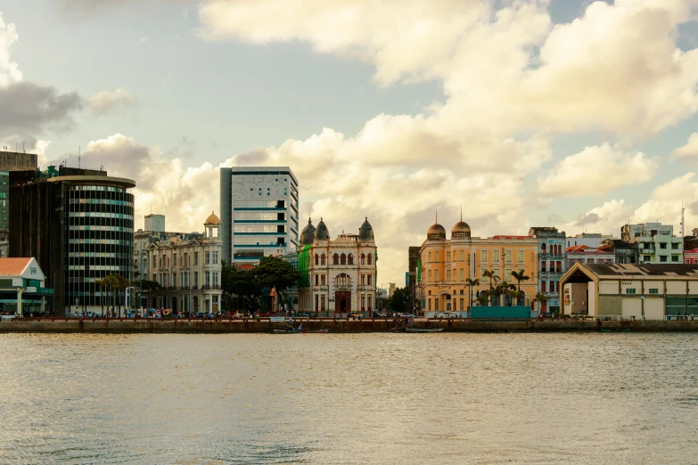 a river flowing through a city next to tall buildings