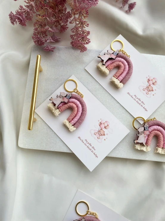 two earrings on top of a card with a pair of scissors