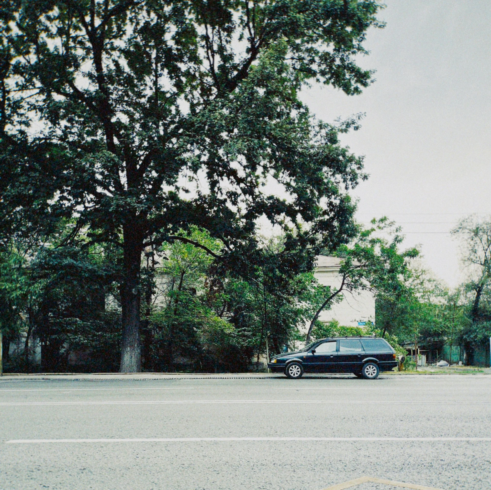 an old fashioned police car parked near some trees