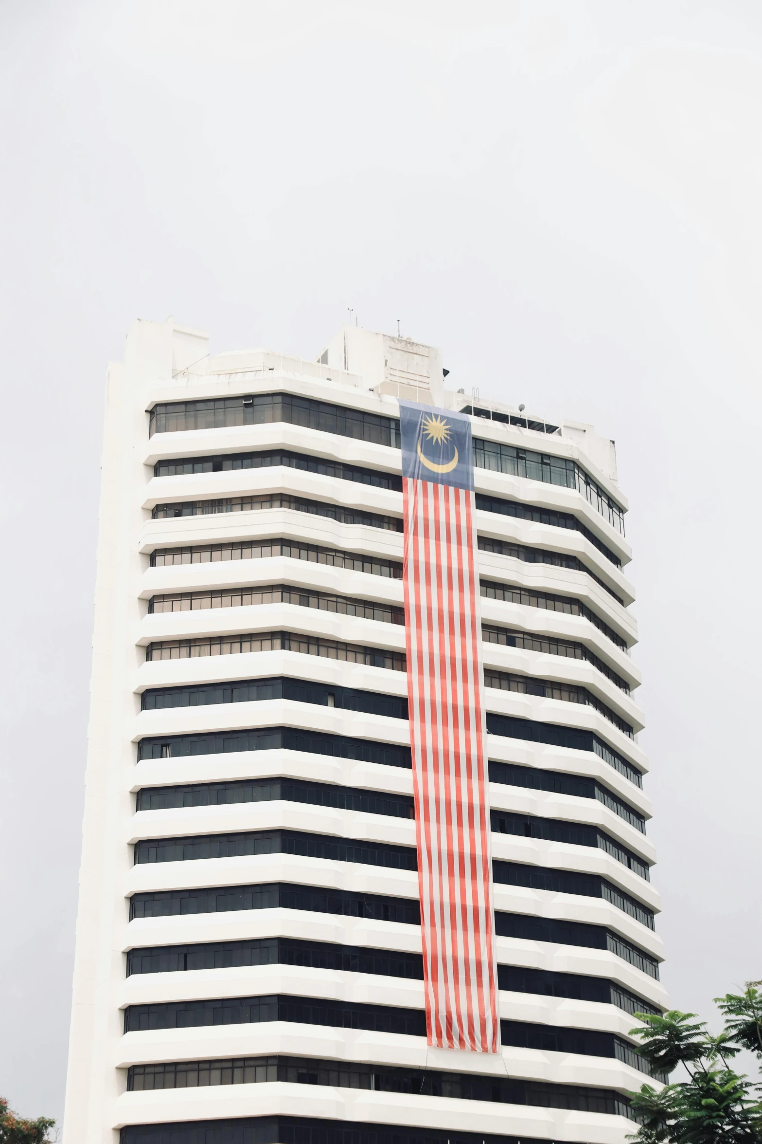 a tall building with a giant flag in the windows