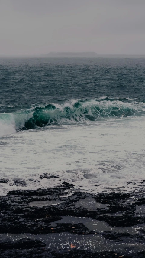 a man riding a surfboard on top of a wave