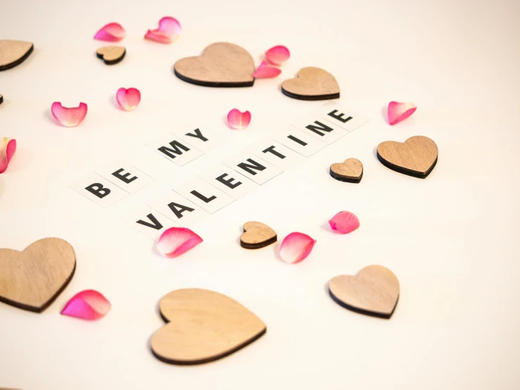 a valentine's day display with hearts, a word written in wooden letters