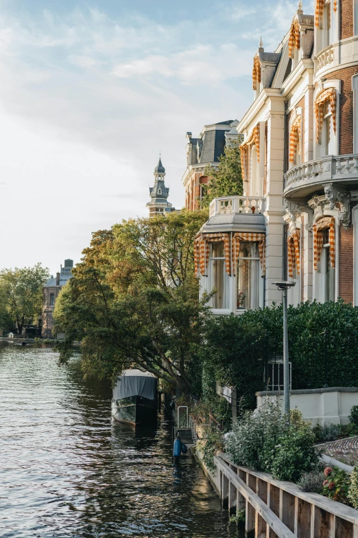 buildings lining the water with a man standing in the boat