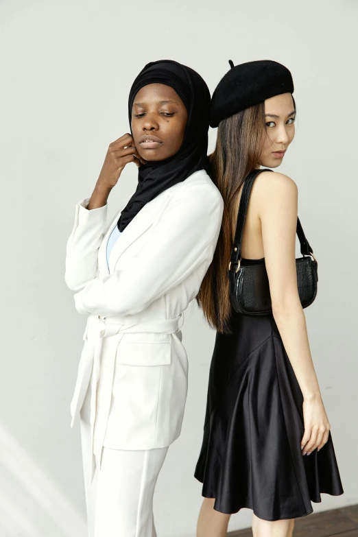 two young women in their twenties are posing