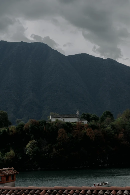 the mountains look very high above the water