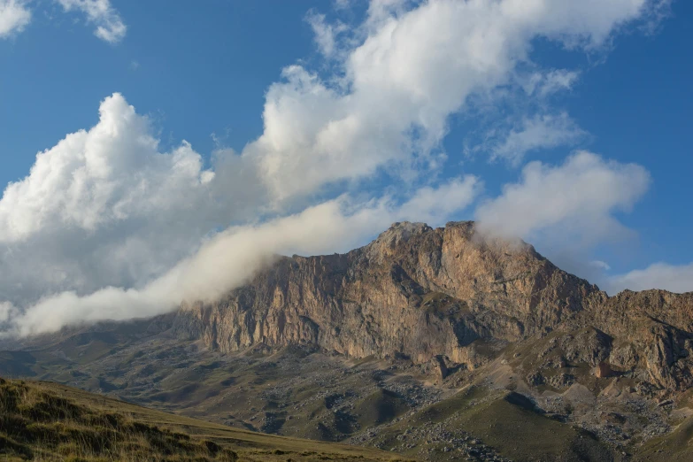 an airplane flying in the sky over a mountain