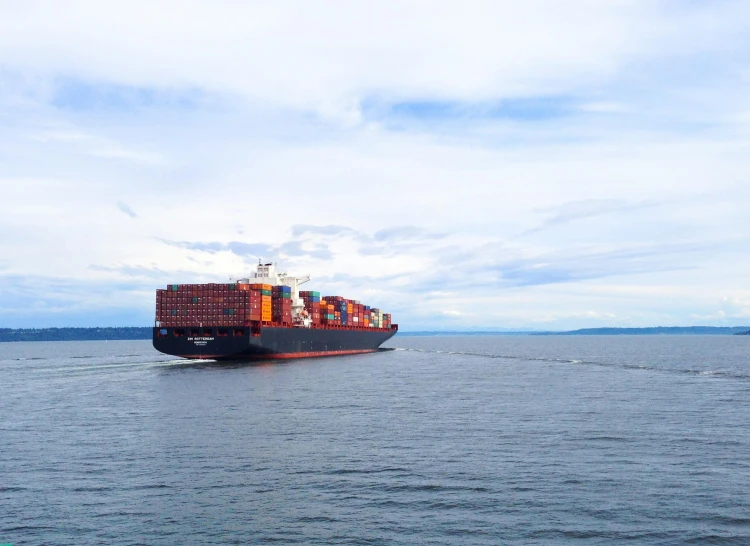 a large cargo ship floating across the water